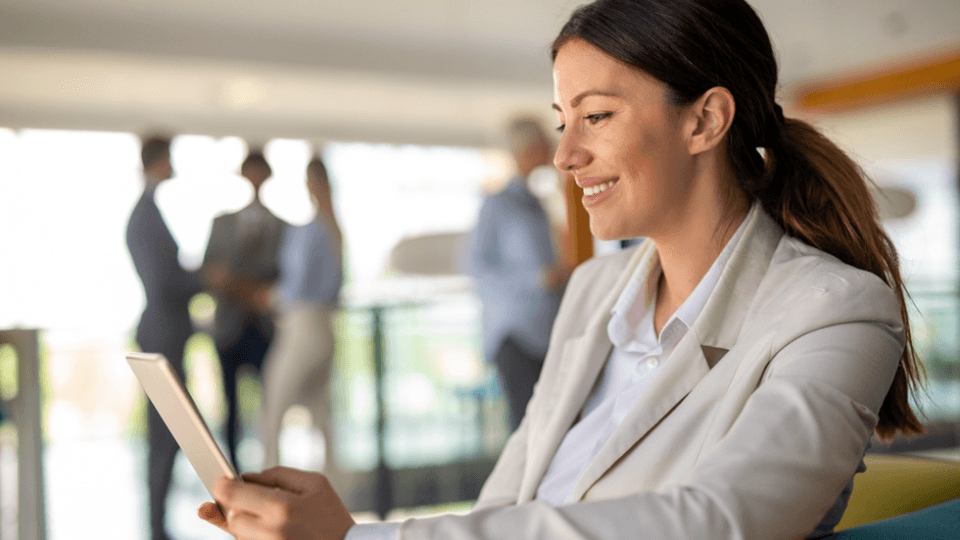 woman on tablet smiling 