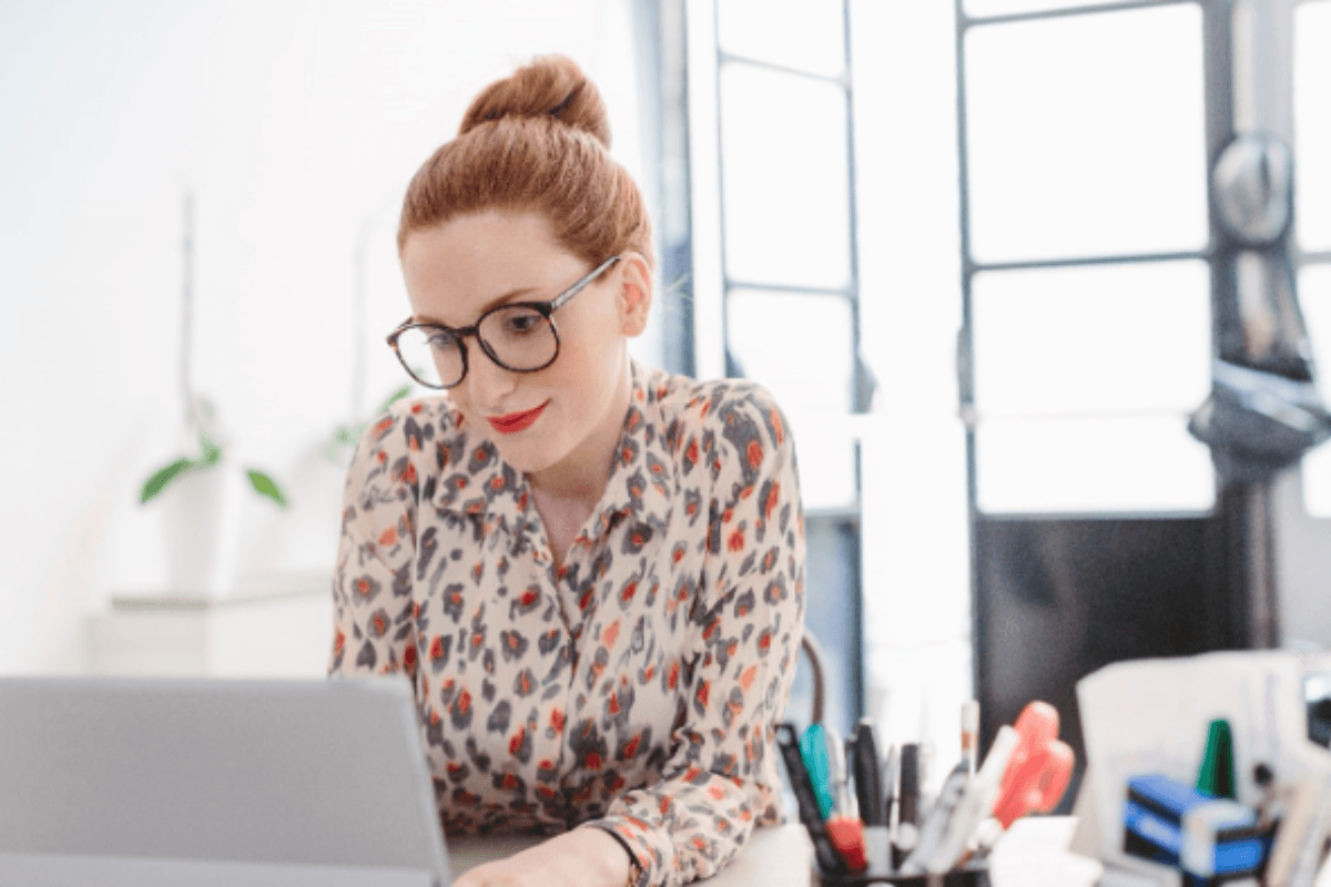 Red haired woman on laptop