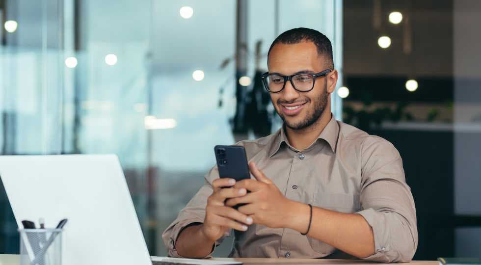 man on phone sitting at desk