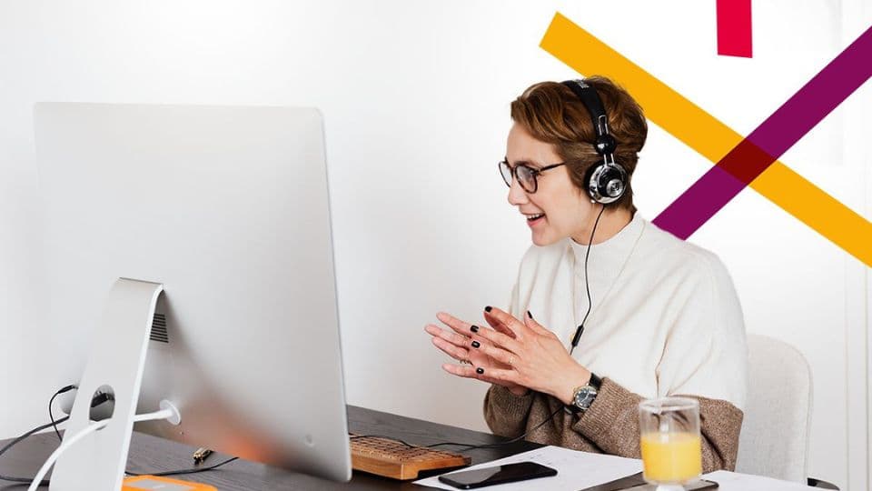 Person at desk with big screen