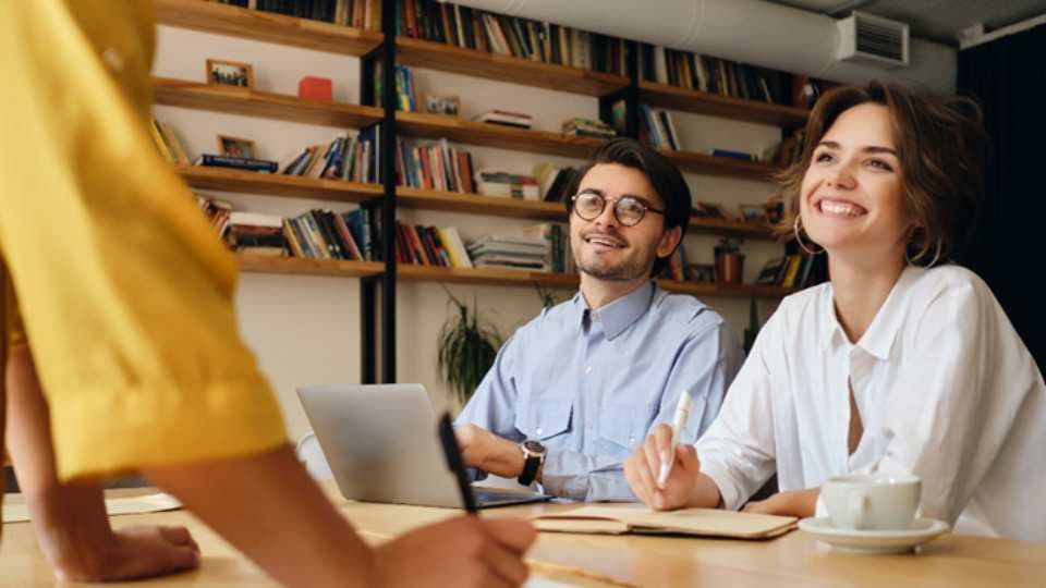 Young couple at desk smiling