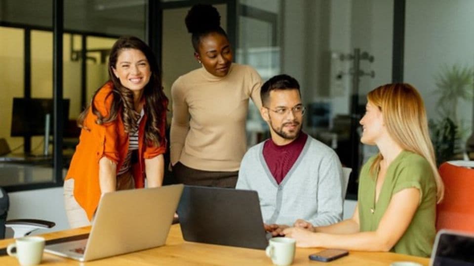 Group of people smiling at desk