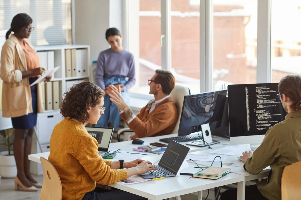 Group of people as desks with computers