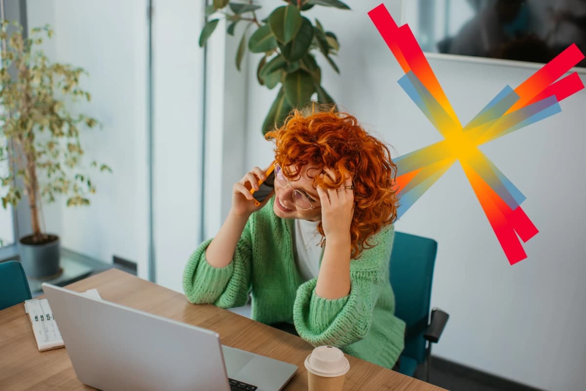 Woman with red hair and green shirt at desk